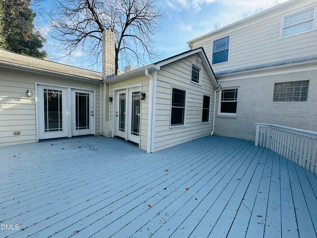 a view of backyard with deck and wooden floor