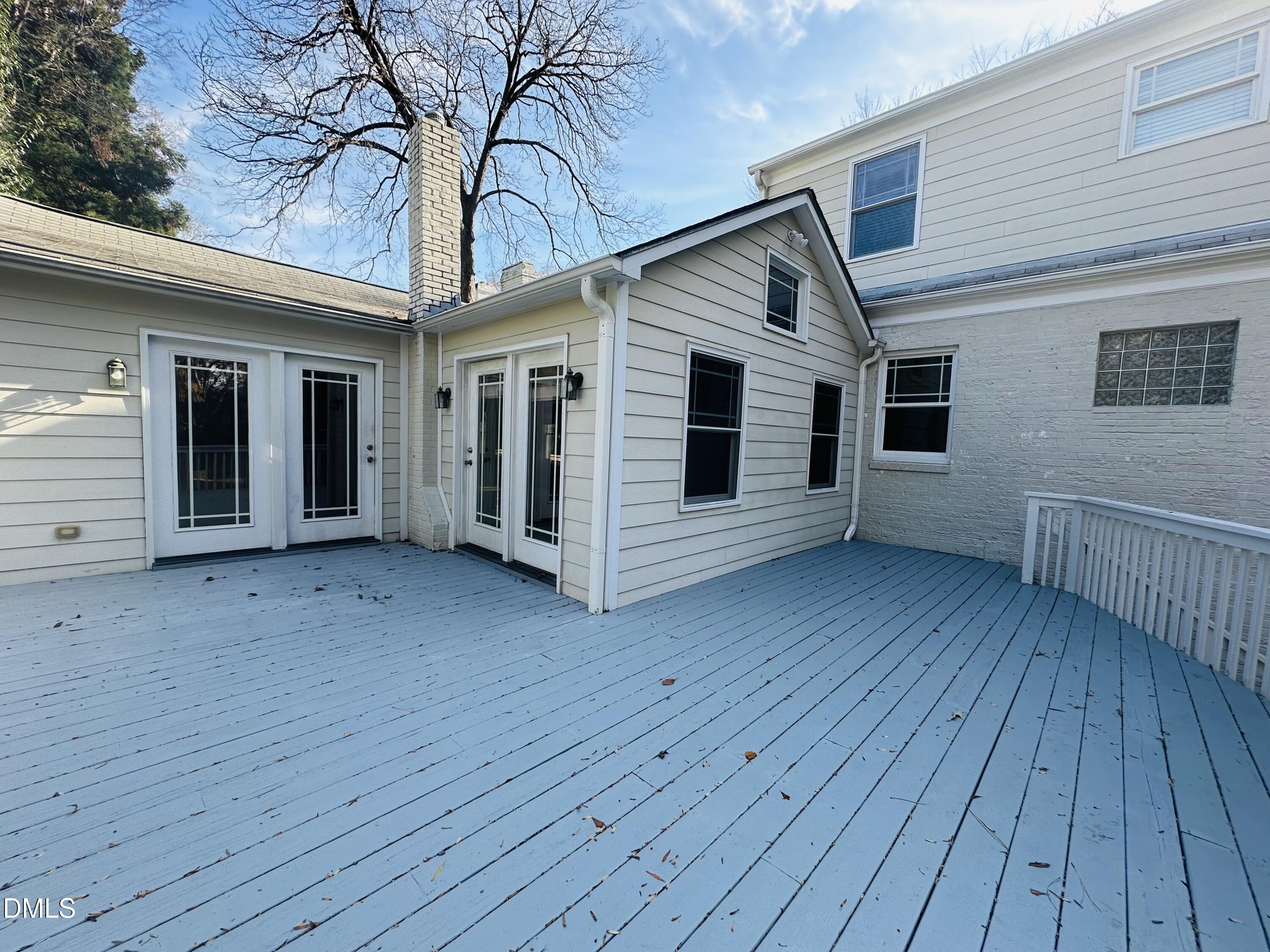 2610 Dover Road Raleigh, NC 27608 - Photo 47 of 53 a view of a house with wooden deck and a yard