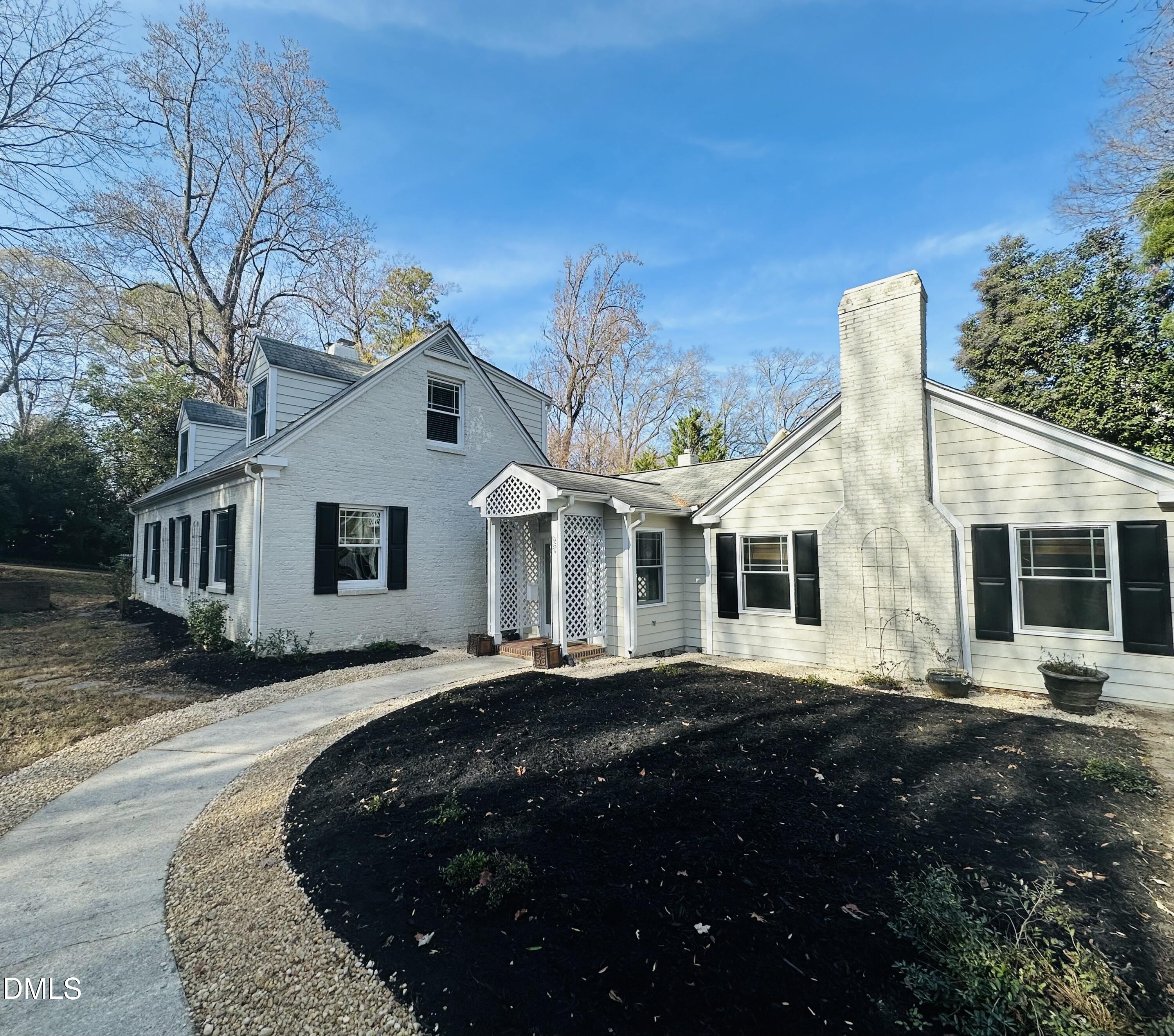 2610 Dover Road Raleigh, NC 27608 - Photo 7 of 53 a front view of a house with a garden