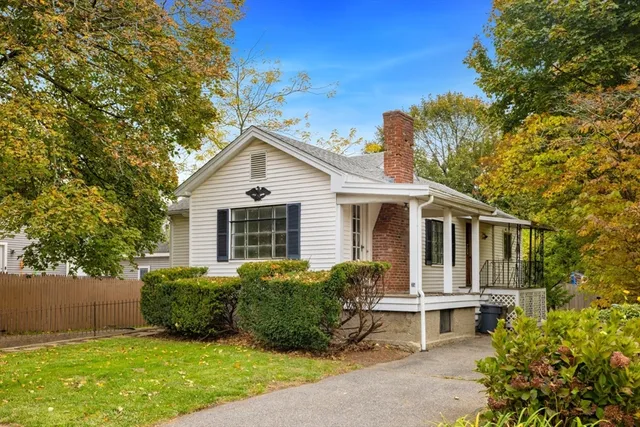 a view of a house with a yard and sitting area