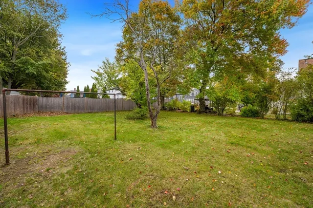 a backyard of a house with table and chairs