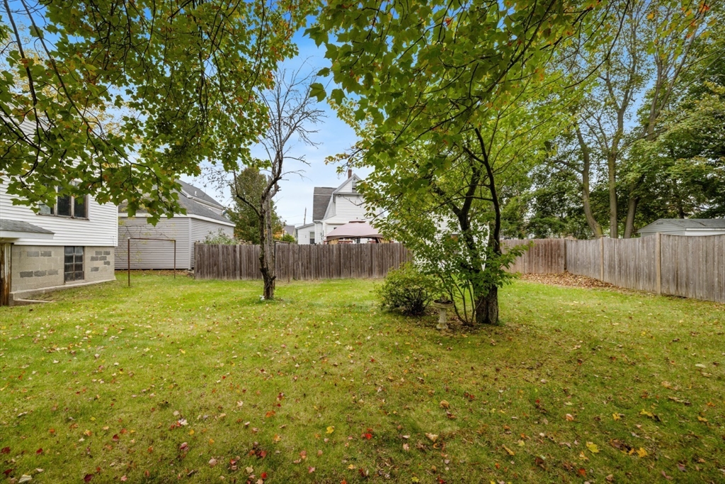 35 Summer Street Saugus, MA 01906 - Photo 29 of 31 a backyard of a house with plants and large tree