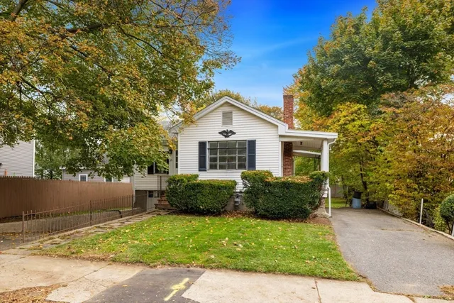 a view of house with a yard and a garden