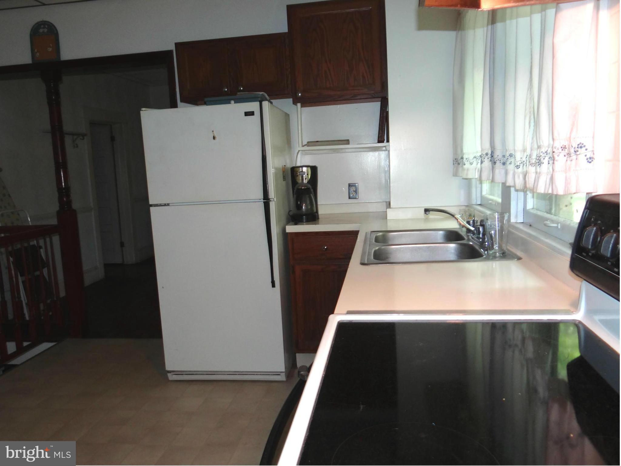 2902 Ridge Road Baltimore, MD 21244 - Photo 2 of 23 a kitchen with a refrigerator a stove a sink and a window