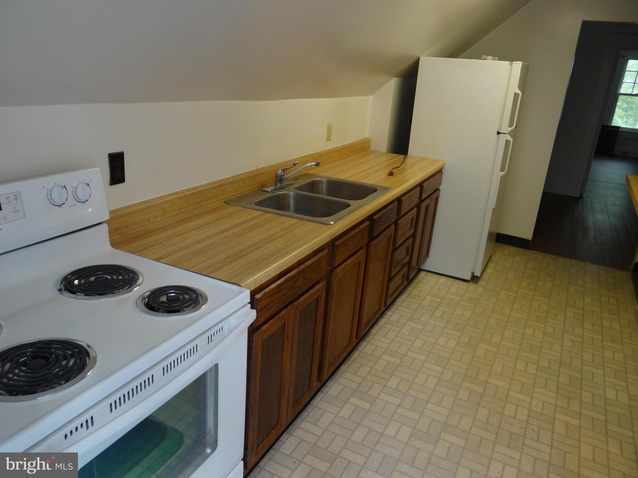 2902 Ridge Road Baltimore, MD 21244 - Photo 14 of 23 a kitchen with a stove and a refrigerator