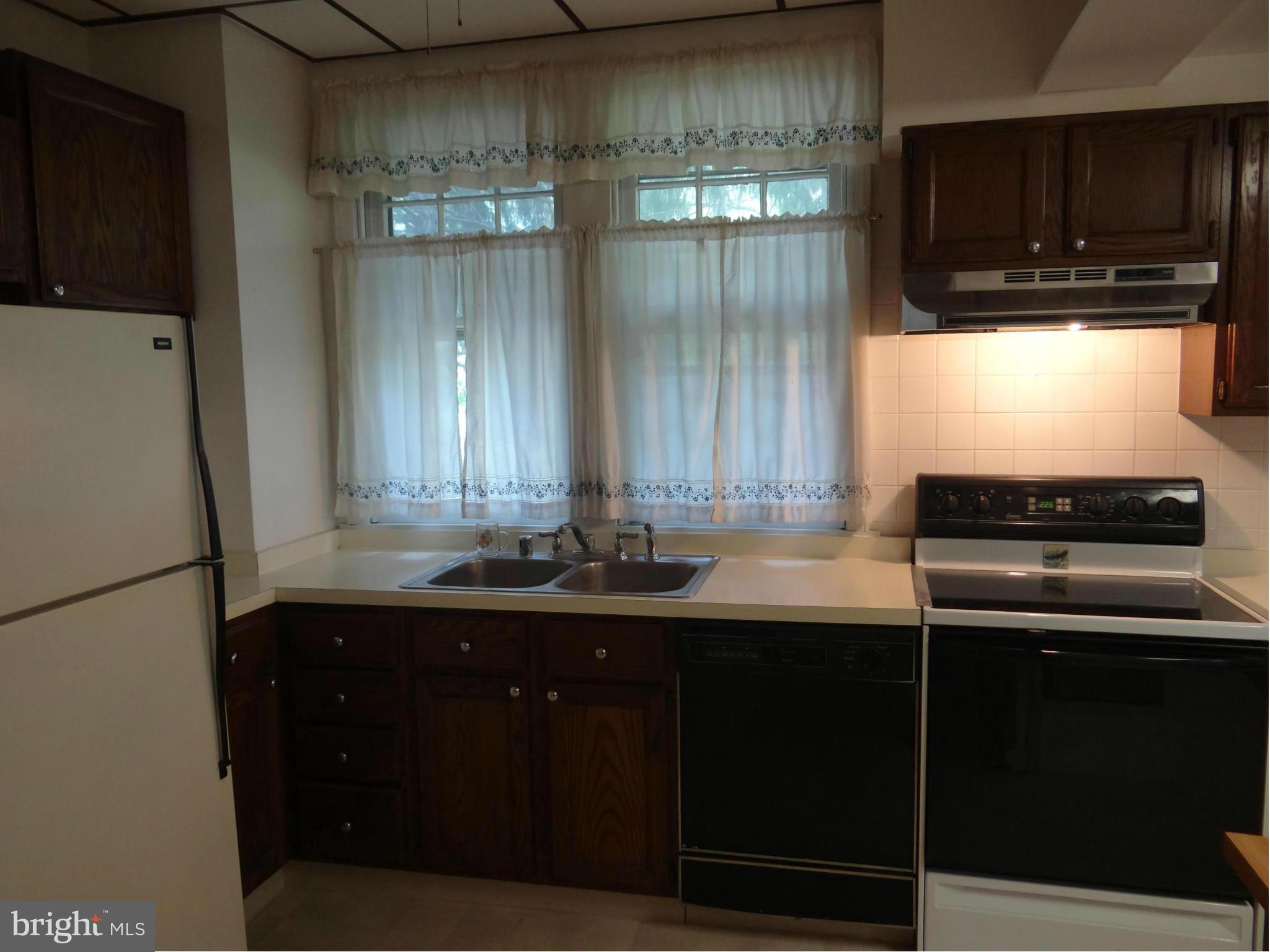 2902 Ridge Road Baltimore, MD 21244 - Photo 6 of 23 a kitchen with a sink and a refrigerator