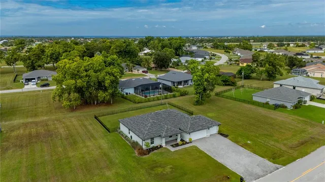 an aerial view of a house with a yard