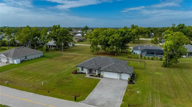 an aerial view of a house with a yard
