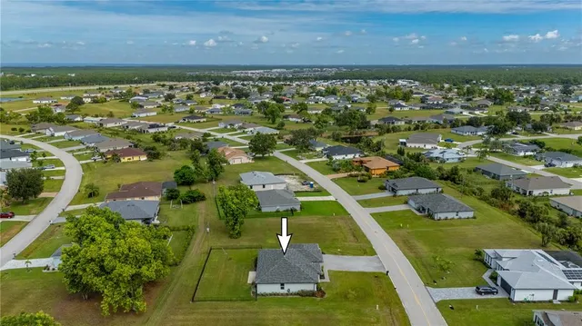 an aerial view of a house with a yard