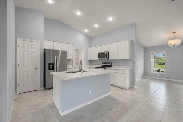 a kitchen with refrigerator and cabinets