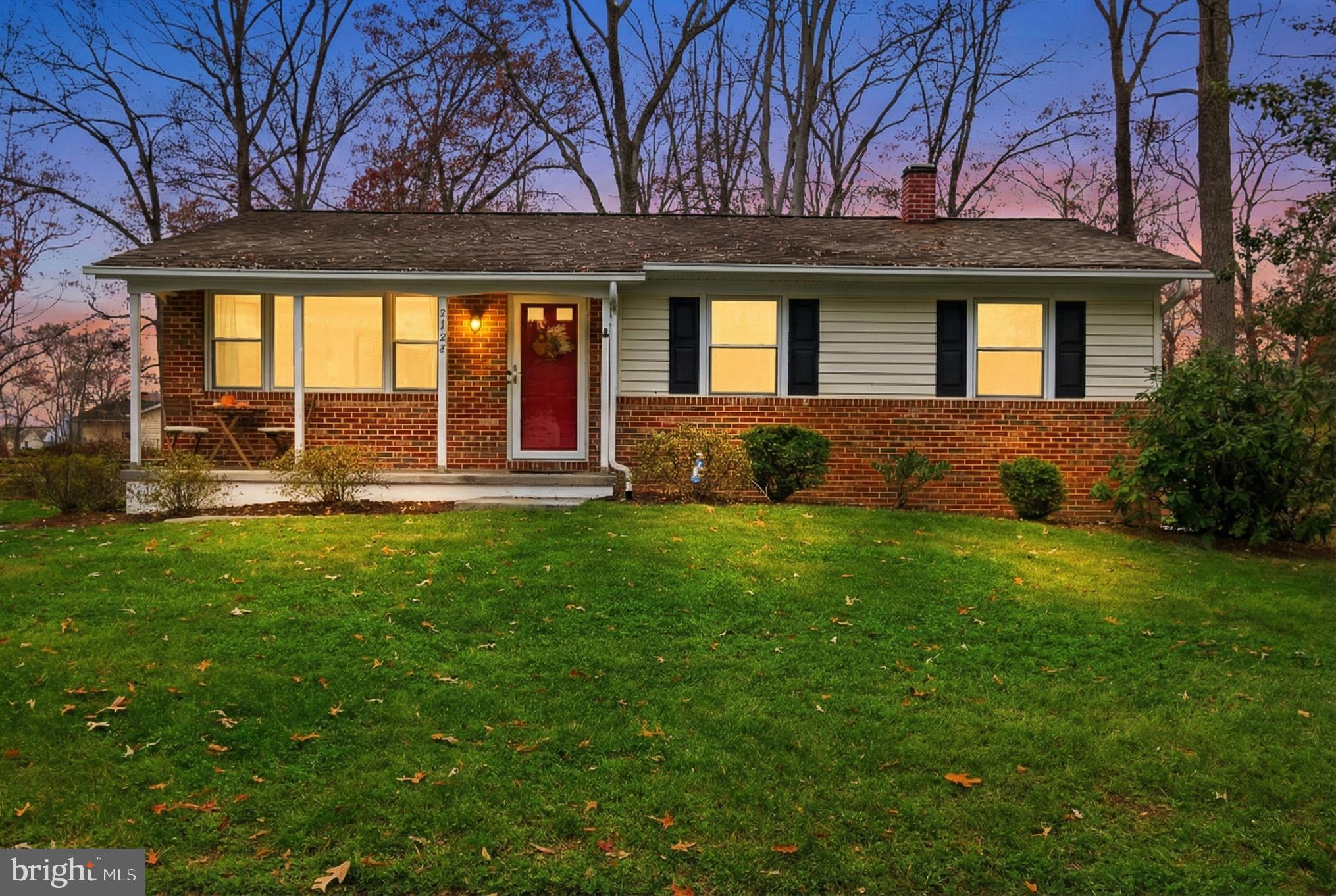 a view of a house with backyard and porch