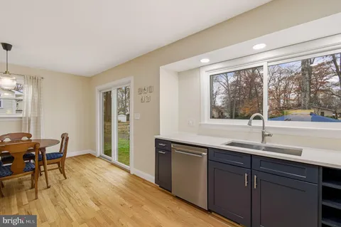 a kitchen with a sink and wooden cabinets