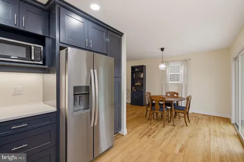 a kitchen with stainless steel appliances granite countertop a refrigerator and microwave