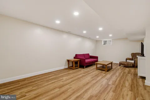 a view of a workspace with furniture and wooden floor