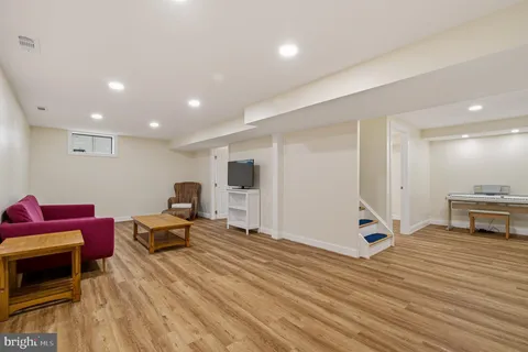 a living room with furniture a wooden floor and a table