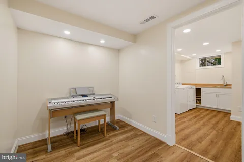 a view of a kitchen with a sink and a refrigerator