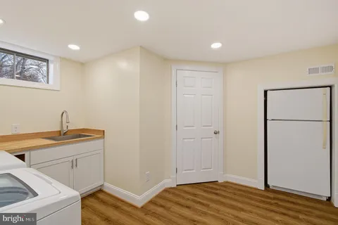 a view of a workspace with furniture and a wooden floor
