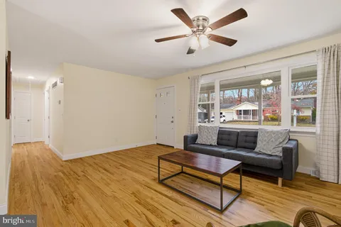 a living room with furniture and view of kitchen