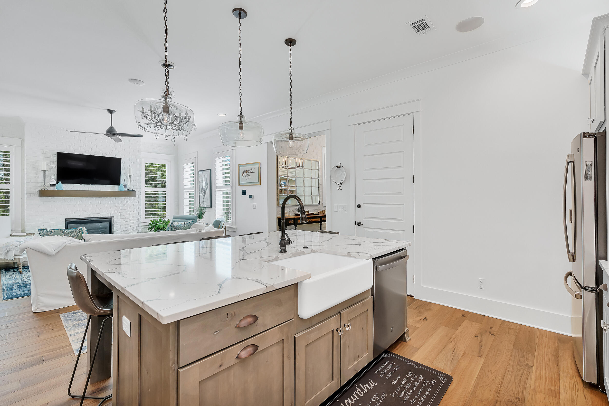 339 Ridgewalk Circle Santa Rosa Beach, FL 32459 - Photo 21 of 57 a view of kitchen island and living room with wooden floor