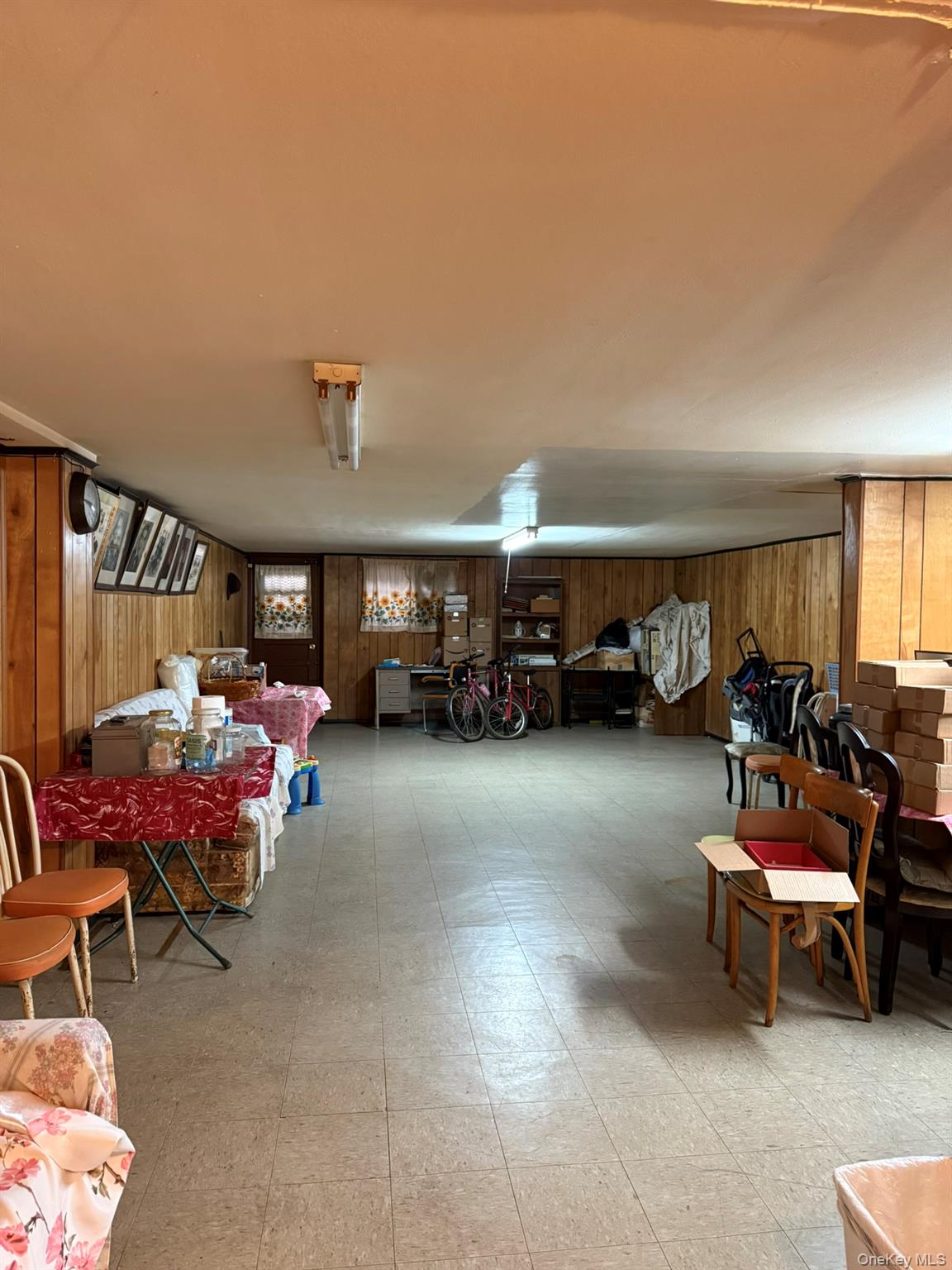 41-38 74th Street Queens, NY 11373 - Photo 14 of 17 a living room with furniture a window and a table