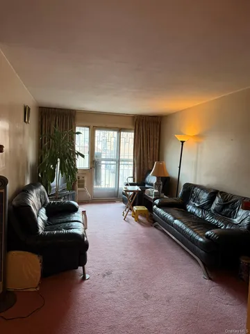 a living room with furniture gym equipment and a large window