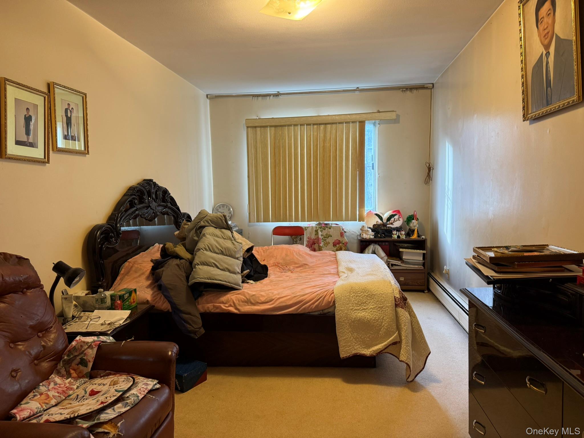 41-38 74th Street Queens, NY 11373 - Photo 10 of 17 a bedroom with a bed and a window