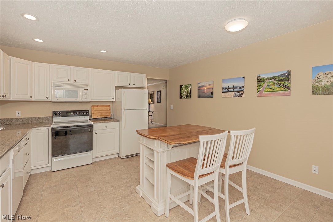 5420 Bartlett Road Bedford, OH 44146 - Photo 10 of 32 Storage is not an issue within this kitchen! Beautiful two-seat island stays.