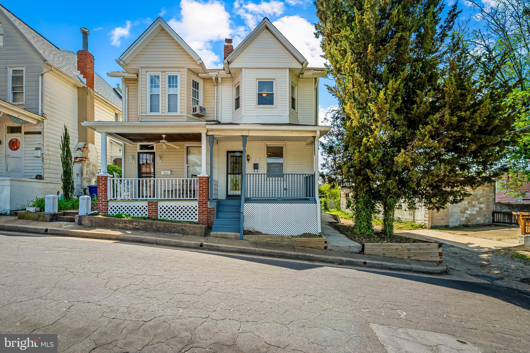a view of a house with street next to a road