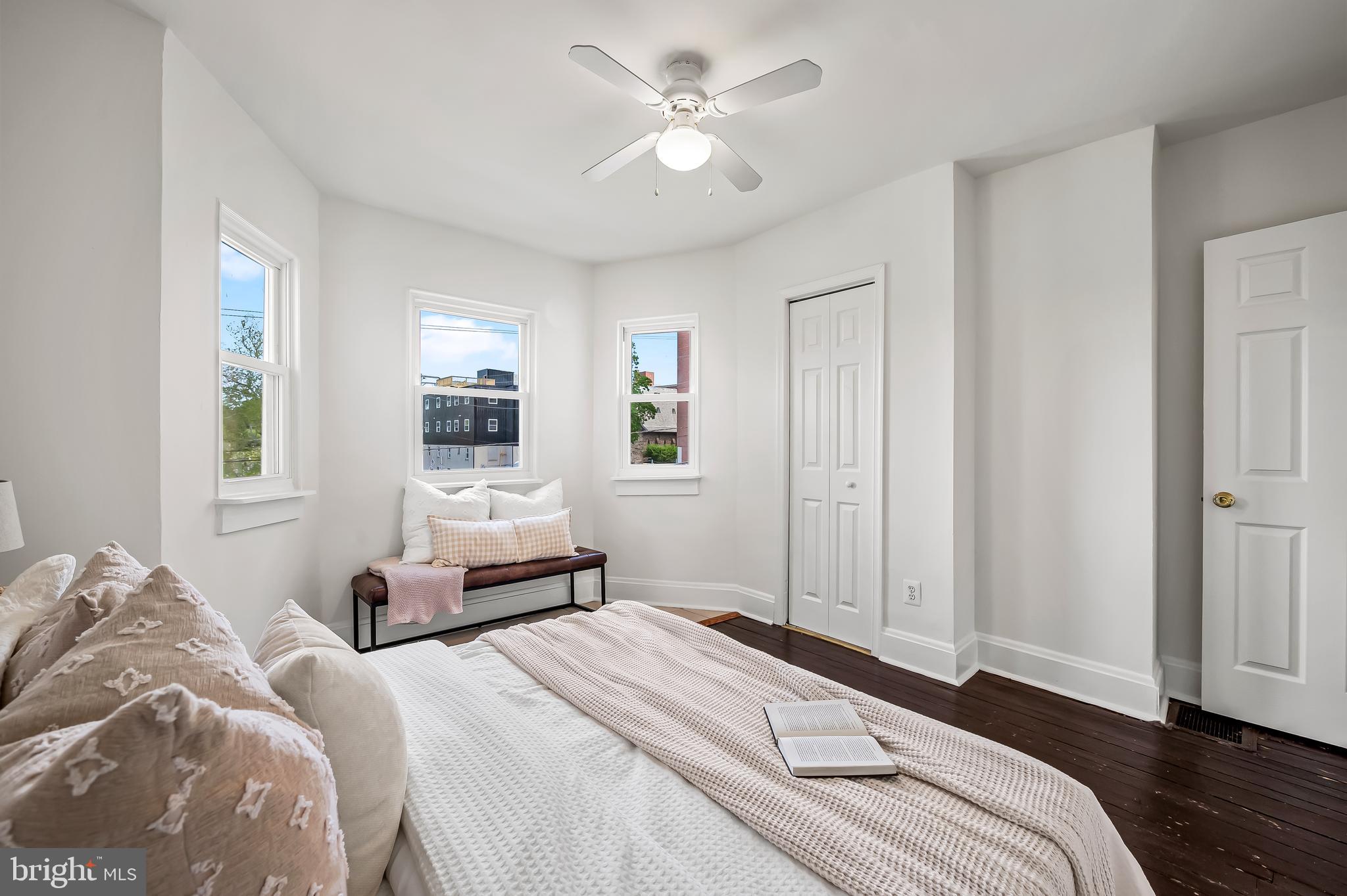 1015 Rectory Lane Baltimore, MD 21211 - Photo 13 of 28 a bedroom with a large bed and wooden floor