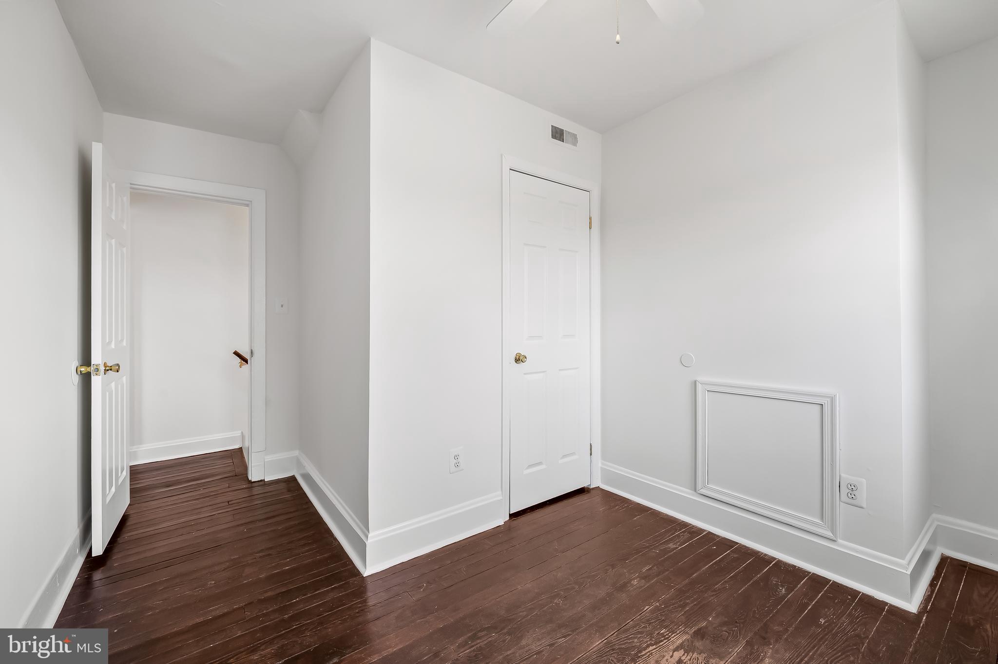 1015 Rectory Lane Baltimore, MD 21211 - Photo 16 of 28 a view of an empty room with wooden floor