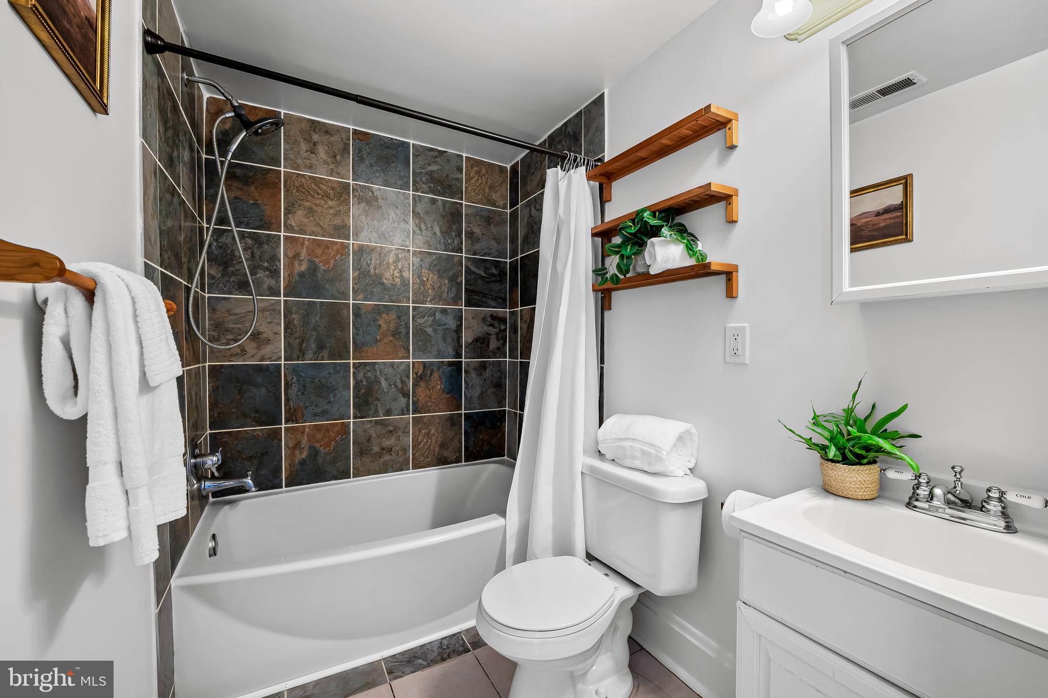 1015 Rectory Lane Baltimore, MD 21211 - Photo 17 of 28 a bathroom with a sink toilet and shower