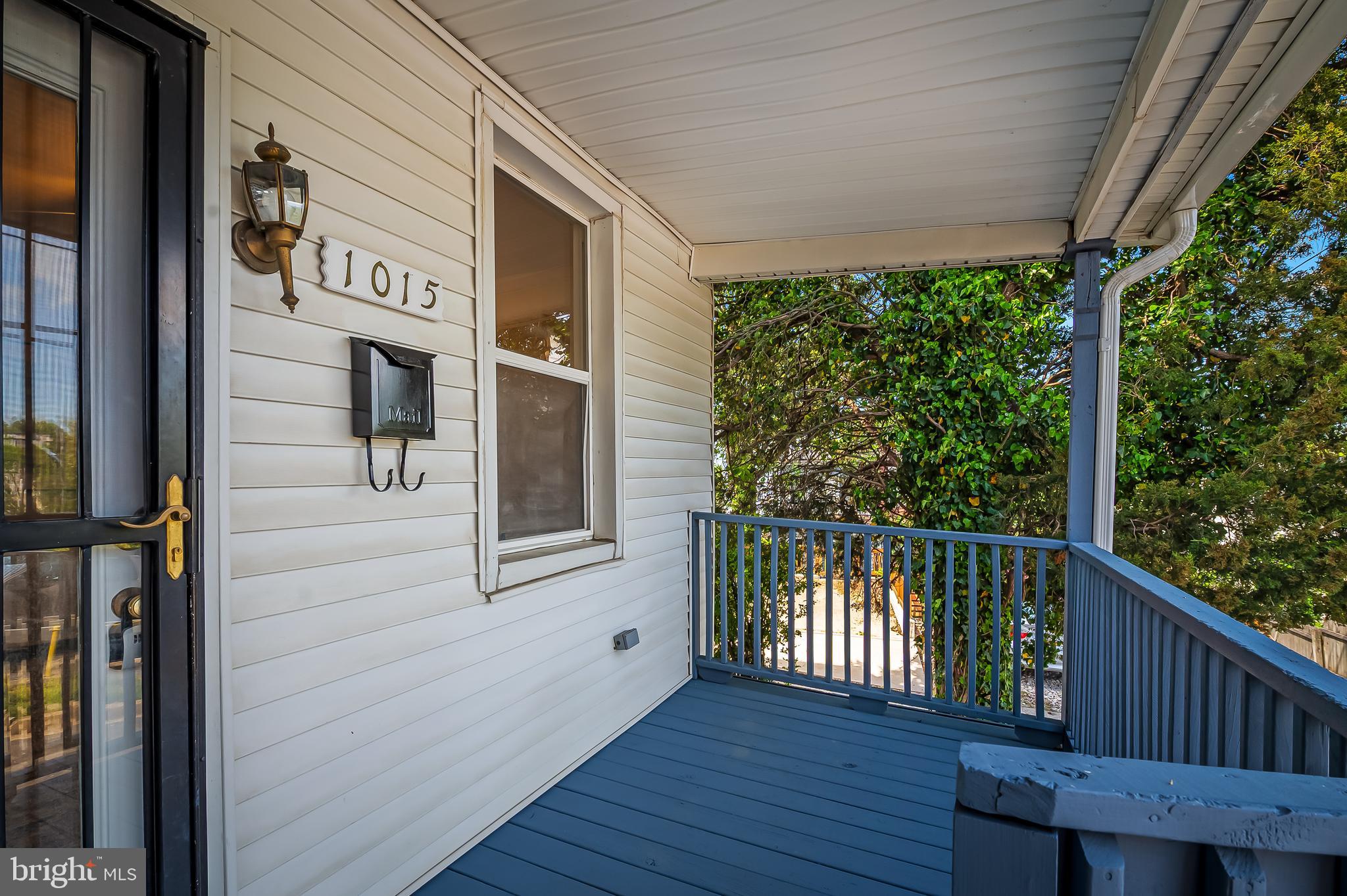 1015 Rectory Lane Baltimore, MD 21211 - Photo 23 of 28 a view of a porch with wooden floor and iron stairs