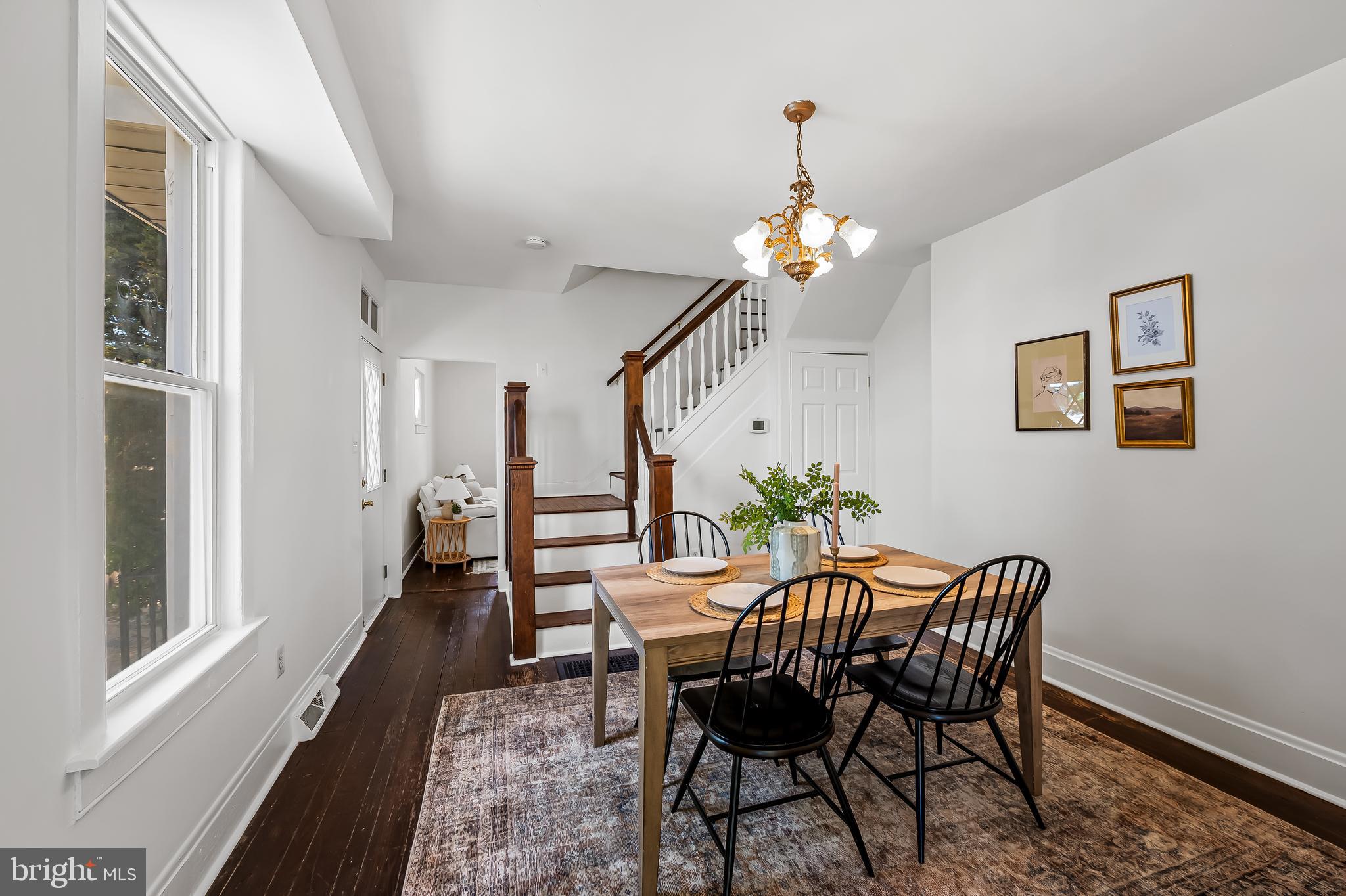 1015 Rectory Lane Baltimore, MD 21211 - Photo 7 of 28 a dining room with furniture a chandelier and wooden floor