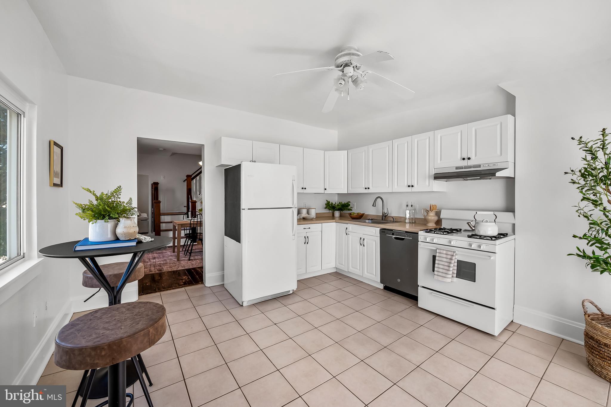 1015 Rectory Lane Baltimore, MD 21211 - Photo 8 of 28 a kitchen with a refrigerator and a coffee table