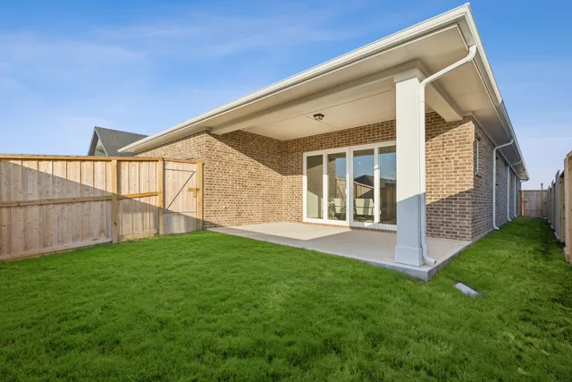 a view of an house with backyard and porch