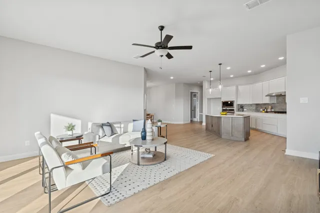 a living room with furniture and kitchen view