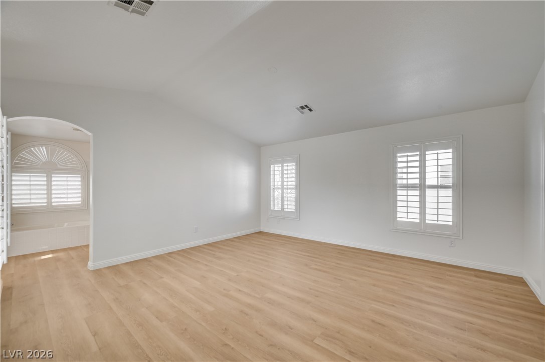 8918 Houston Ridge Avenue Las Vegas, NV 89178 - Photo 14 of 35 Refined wood-look flooring enhances the spaciousness of this luminous room, featuring pristine plantation shutters.