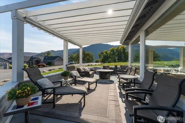 a view of a patio with couches table and chairs and potted plants