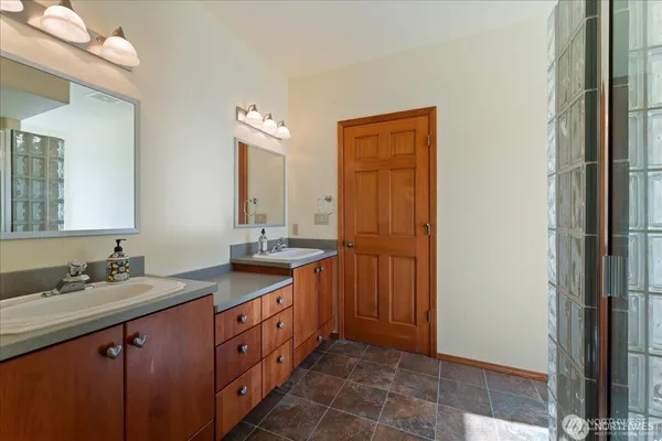a bathroom with a shower and a sink