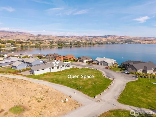 an aerial view of residential houses with outdoor space and swimming pool
