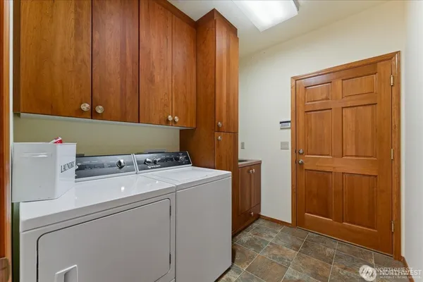 a view of a hallway with staircase and closet
