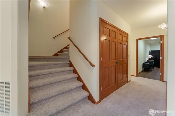 a living room with furniture ceiling fan and a window