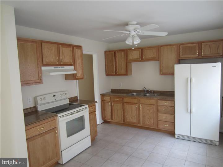 20 Johnstown Road Elkton, MD 21921 - Photo 2 of 23 a kitchen with granite countertop a sink and a refrigerator