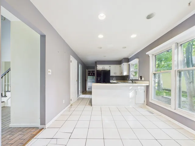 a view of an empty room with a fireplace and a window