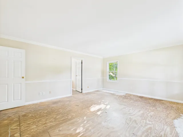 a bathroom with bathtub and window