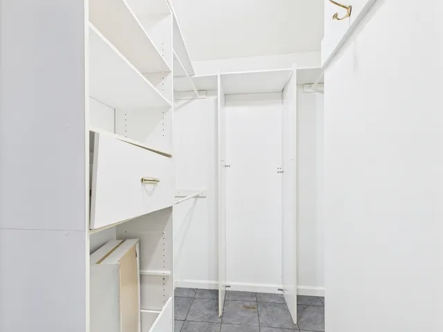 a view of a hallway with wooden floor and entryway