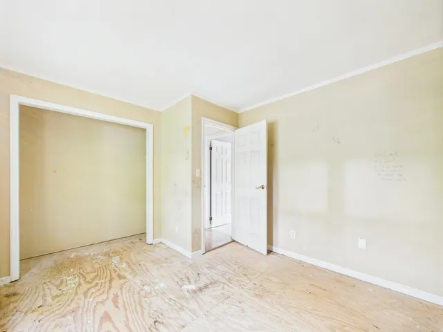 an empty room with closet and mirrors
