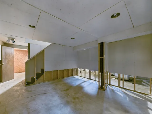 a view of a hallway with wooden shelves