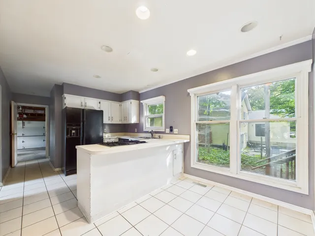 a kitchen with a sink stove and cabinets