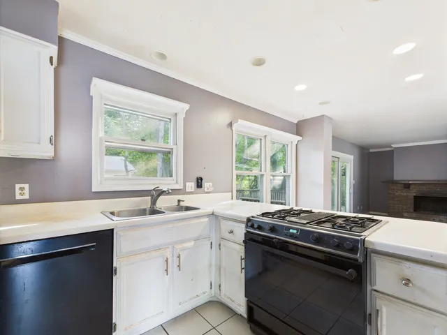 a kitchen with a refrigerator sink and cabinets